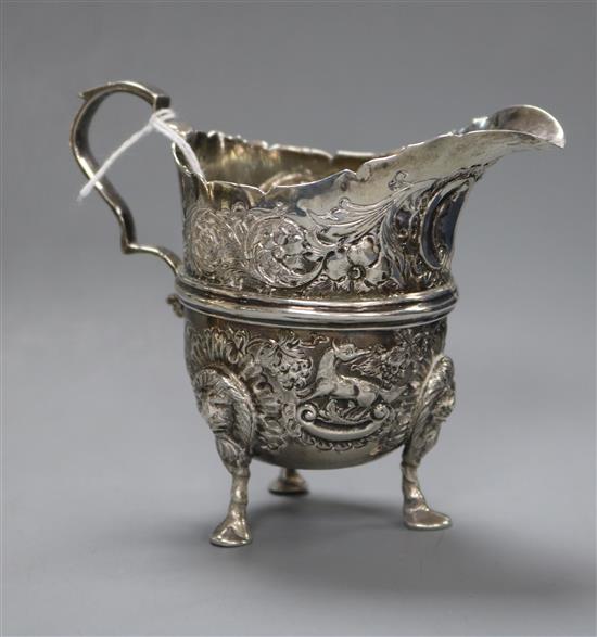 A George V embossed silver cream jug, Charles Lambe, Dublin, 1921, 8.4cm.